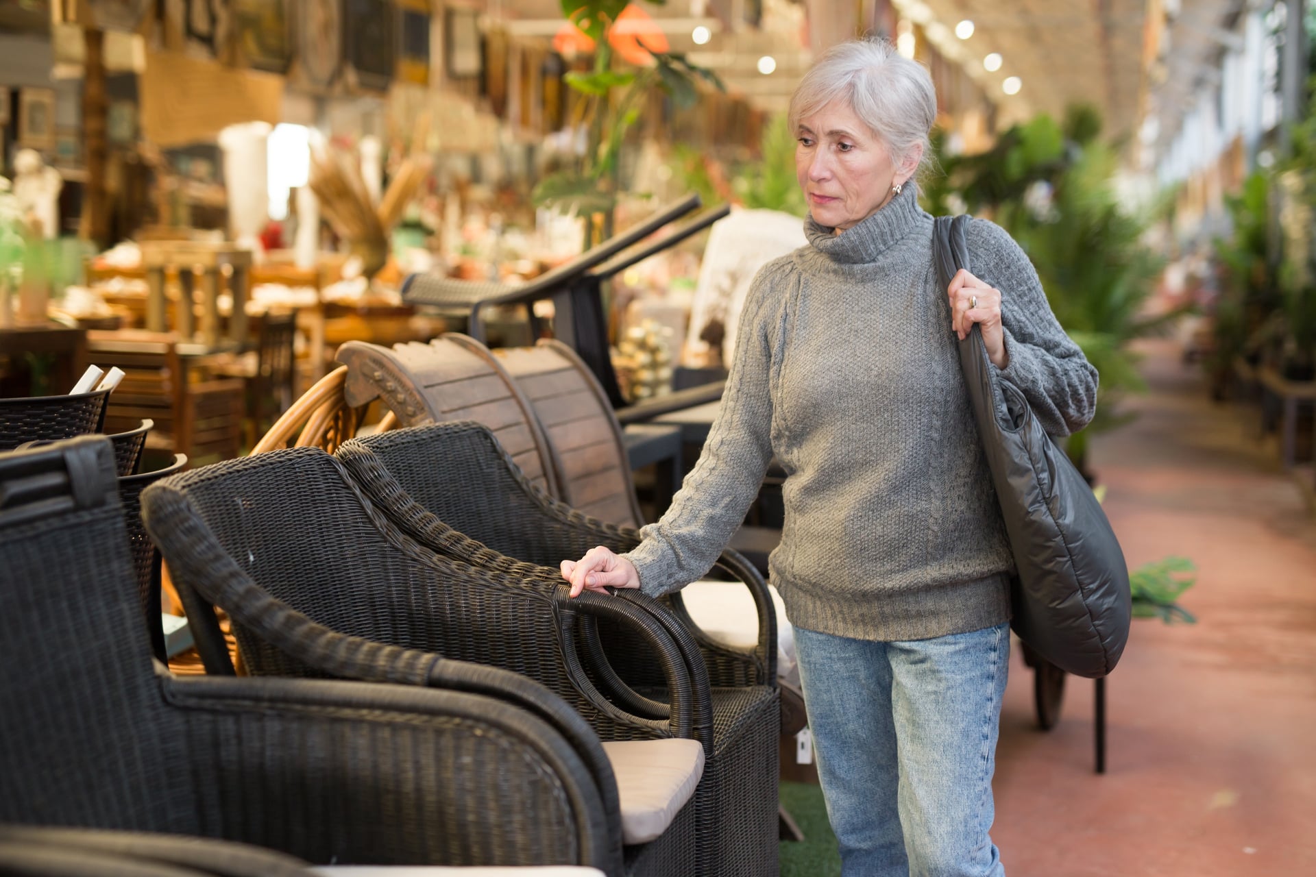 Positive,Aged,Female,Shopper,Choosing,Resin,Wicker,Chairs,For,Using